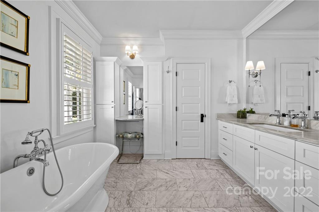 2156 Colony Road Charlotte, NC 28209 - Photo 29 of 46 a spacious bathroom with a double vanity sink tub and mirror