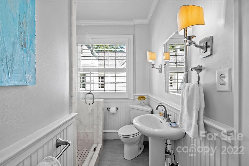 2156 Colony Road Charlotte, NC 28209 - Photo 35 of 46 a bathroom with a sink a toilet and mirror