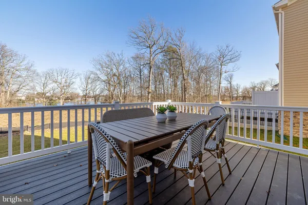 a view of a balcony with wooden floor outdoor seating