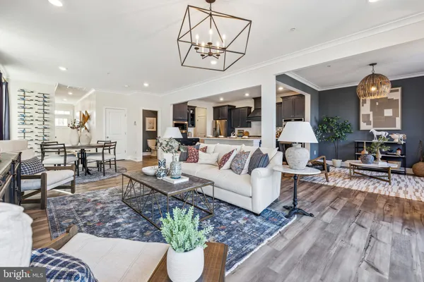 a living room with furniture dining area and a chandelier