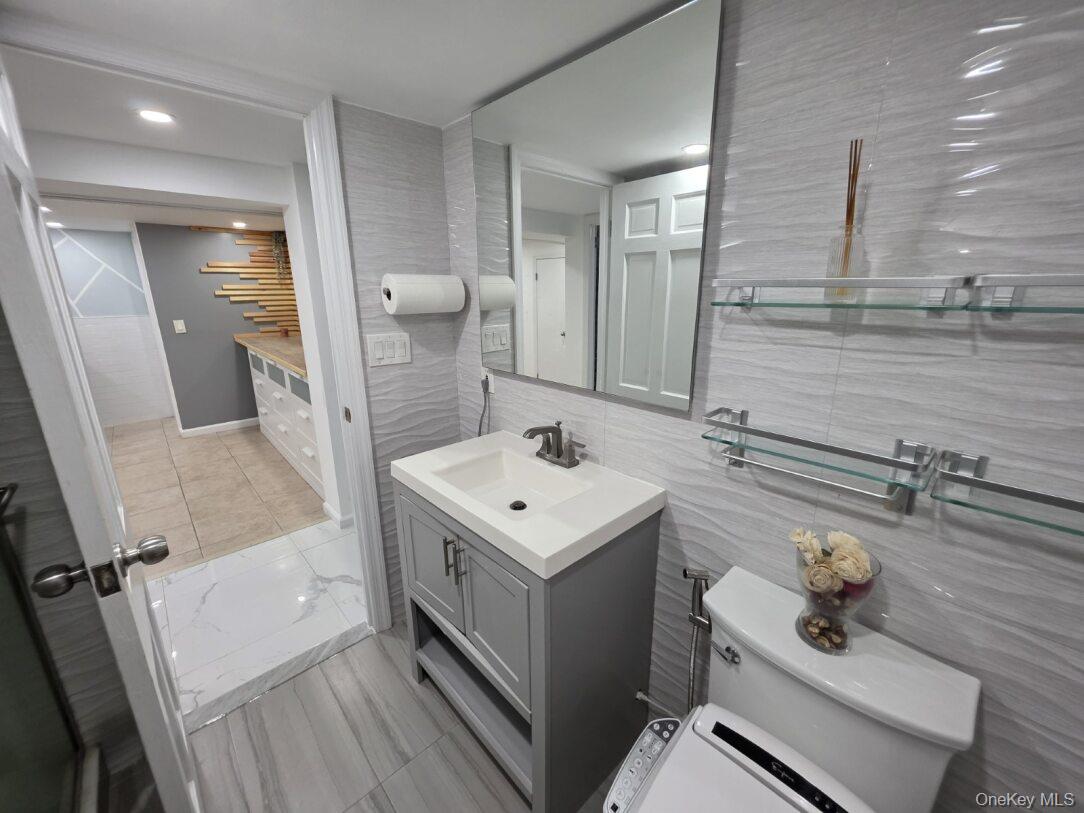 30 Aberdeen Road New Hyde Park, NY 11040 - Photo 23 of 37 a bathroom with a sink a toilet a mirror and shower