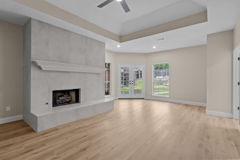 4510 Dexham Road Rowlett, TX 75088 - Photo 15 of 33 wooden floor fireplace and natural light in room