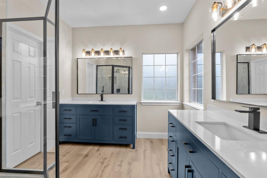 4510 Dexham Road Rowlett, TX 75088 - Photo 16 of 33 a bathroom with a granite countertop sink and a mirror