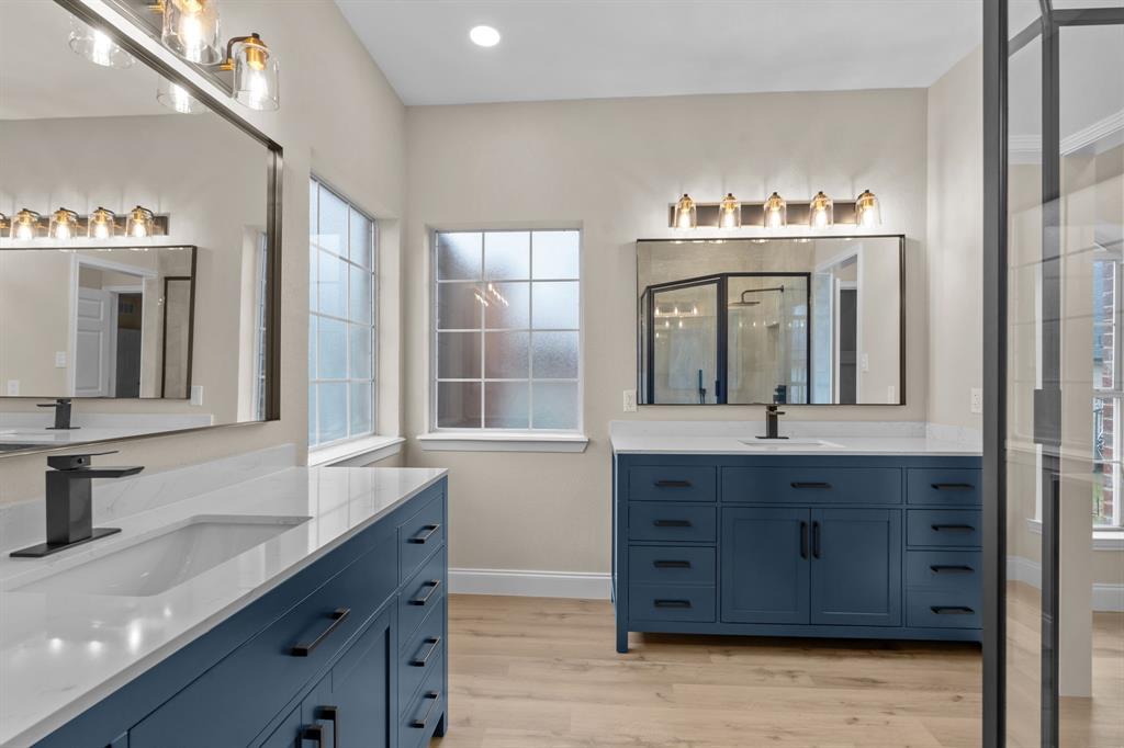 4510 Dexham Road Rowlett, TX 75088 - Photo 17 of 33 a bathroom with a granite countertop sink and a mirror