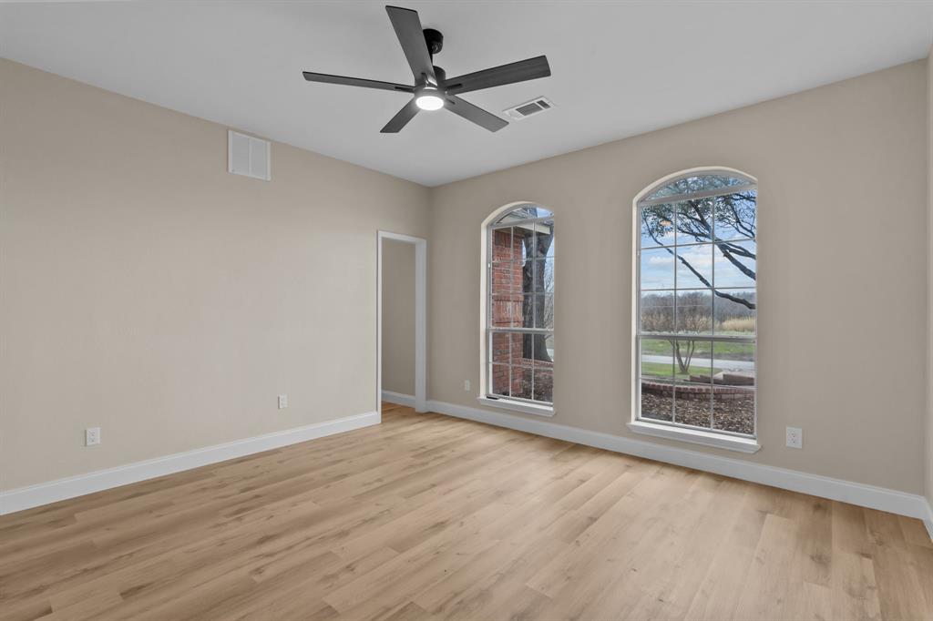 4510 Dexham Road Rowlett, TX 75088 - Photo 20 of 33 a view of an empty room with a window and wooden floor