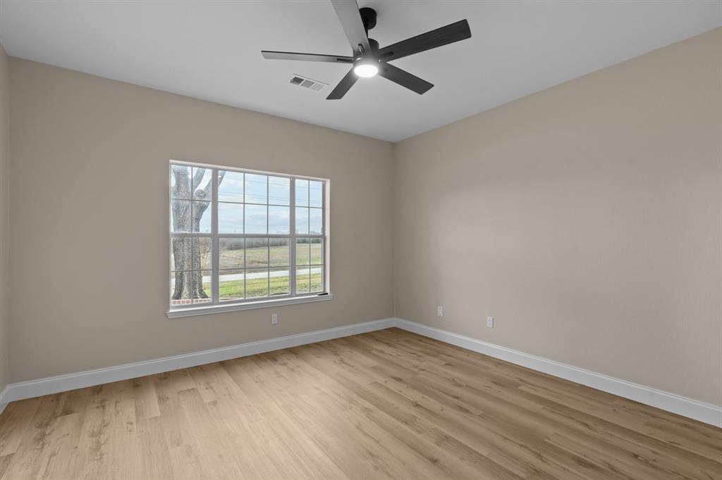 4510 Dexham Road Rowlett, TX 75088 - Photo 22 of 33 wooden floor in an empty room with a window