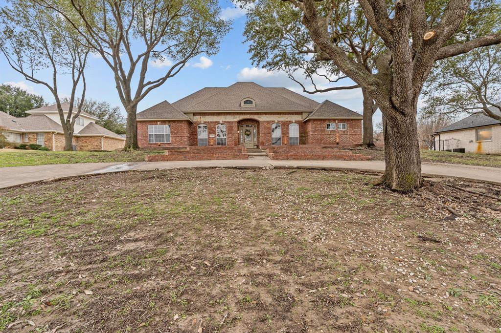 4510 Dexham Road Rowlett, TX 75088 - Photo 32 of 33 a large house with a big yard and large trees