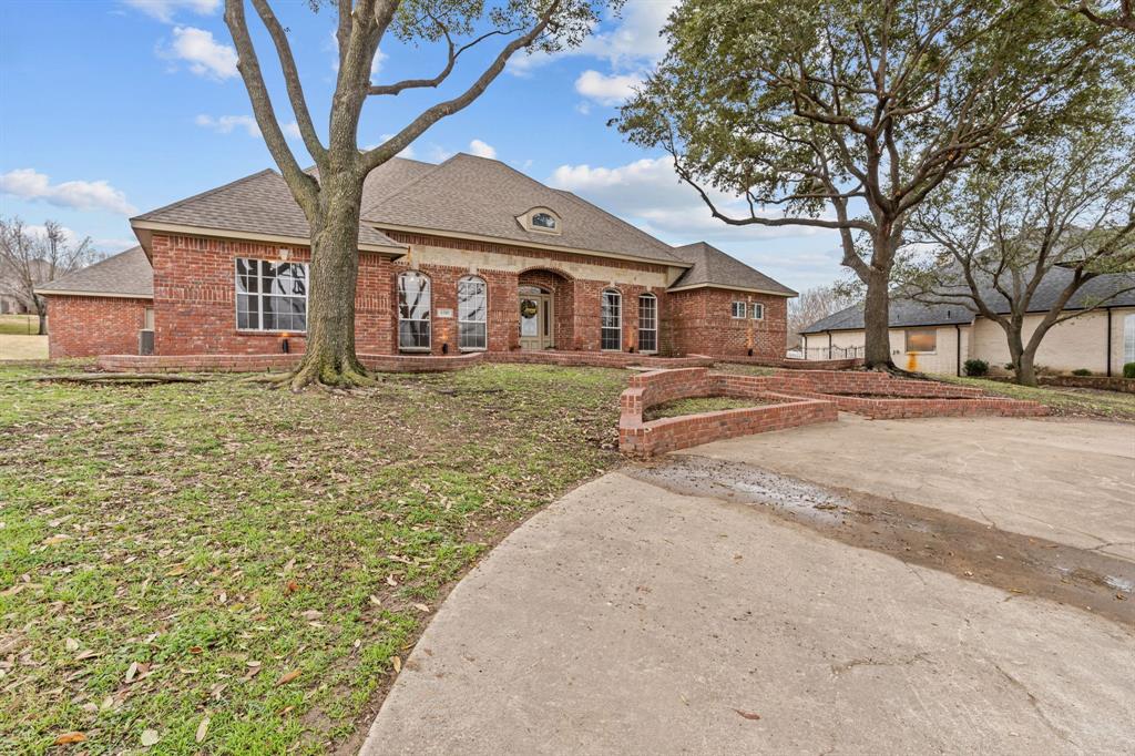 4510 Dexham Road Rowlett, TX 75088 - Photo 4 of 33 a brick house with tree in front of it