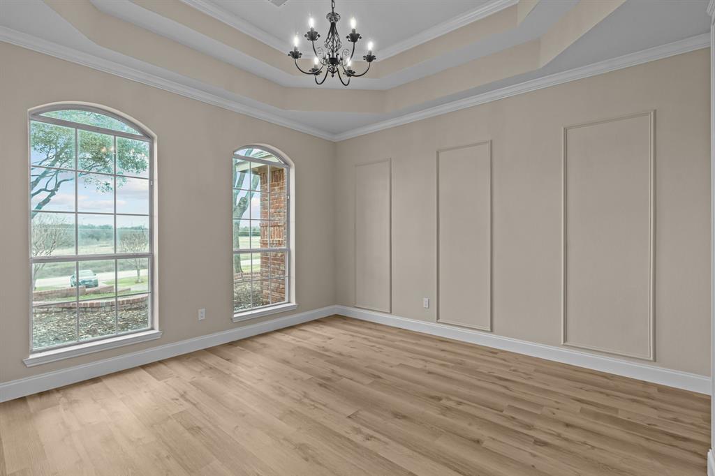 4510 Dexham Road Rowlett, TX 75088 - Photo 8 of 33 a view of an empty room with wooden floor and a window