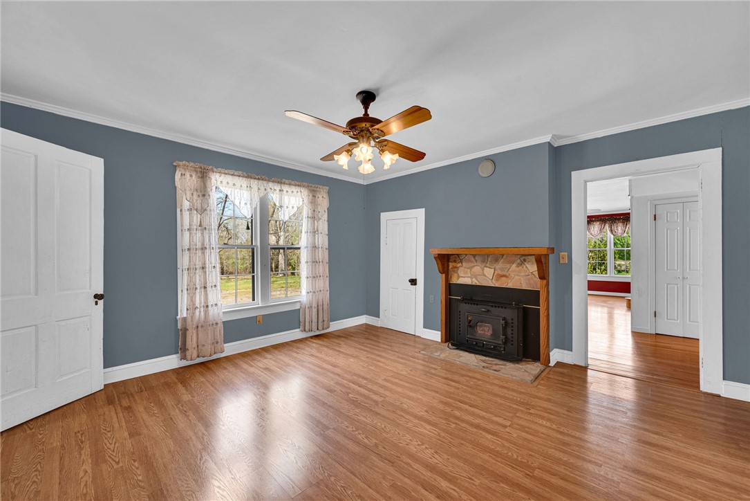 245 Cromer Road Williamston, SC 29697 - Photo 5 of 27 This inviting living space features warm hardwood floors and a cozy fireplace, perfect for relaxing evenings.