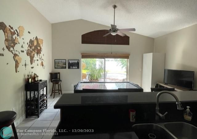 Keystone Lake Pembroke Pines, FL 33029 - Photo 13 of 23 a kitchen with a chandelier a stove and a chandelier