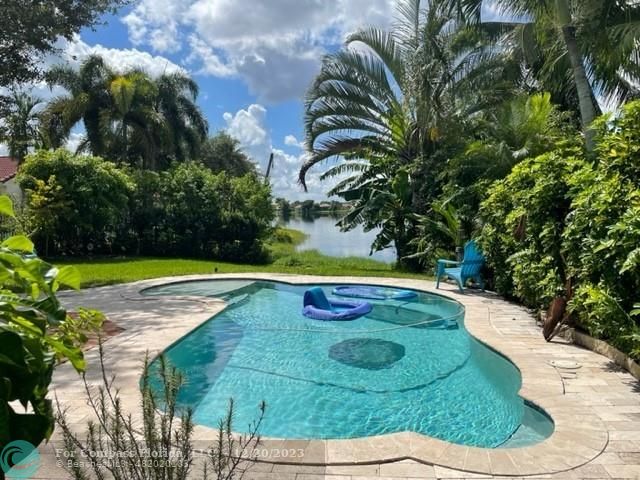 Keystone Lake Pembroke Pines, FL 33029 - Photo 6 of 23 a view of a swimming pool with a yard
