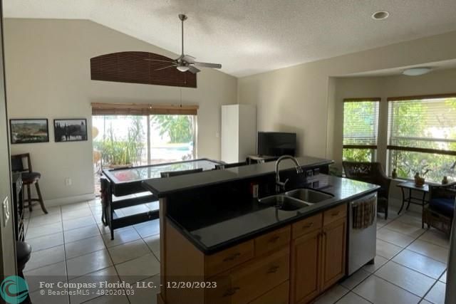 Keystone Lake Pembroke Pines, FL 33029 - Photo 9 of 23 a kitchen with a sink and a stove