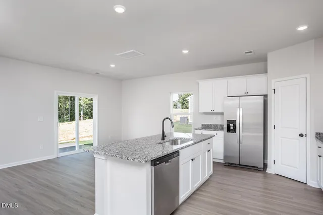 a kitchen with a sink stove and refrigerator