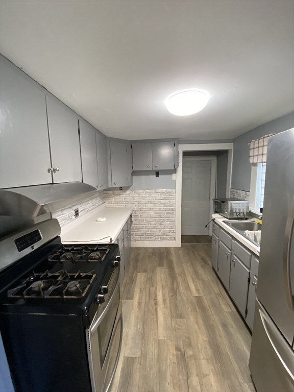 50 Volusia Road Hingham, MA 02043 - Photo 4 of 11 a kitchen with a stove and a refrigerator