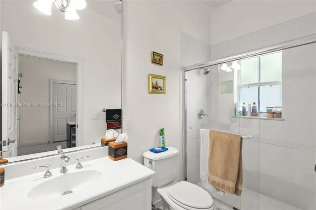 a bathroom with a sink toilet and mirror