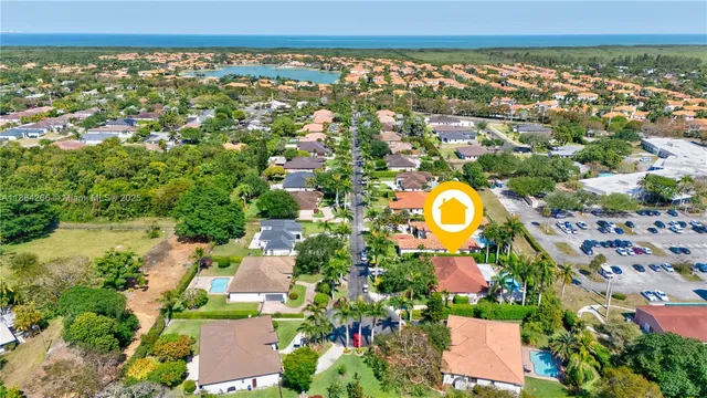 an aerial view of a house with a yard and lake view
