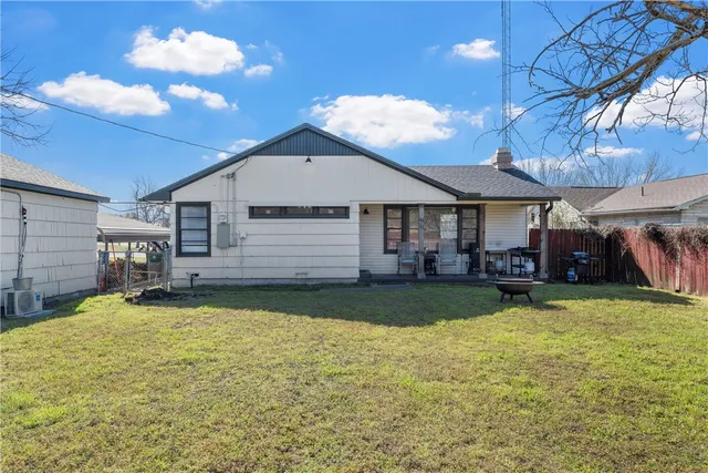 a view of a house with a yard and sitting area