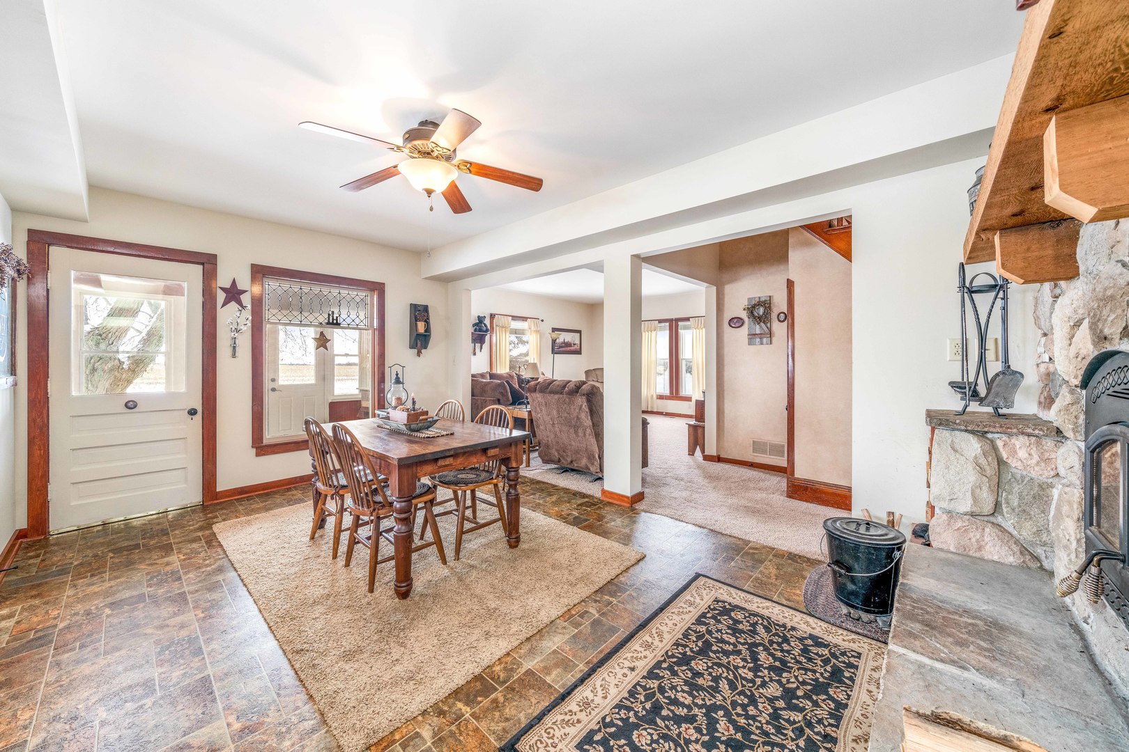 3478 Chicago Road Paw Paw, IL 61353 - Photo 11 of 49 a dining room with wooden floor a chandelier fan a wooden table and chairs