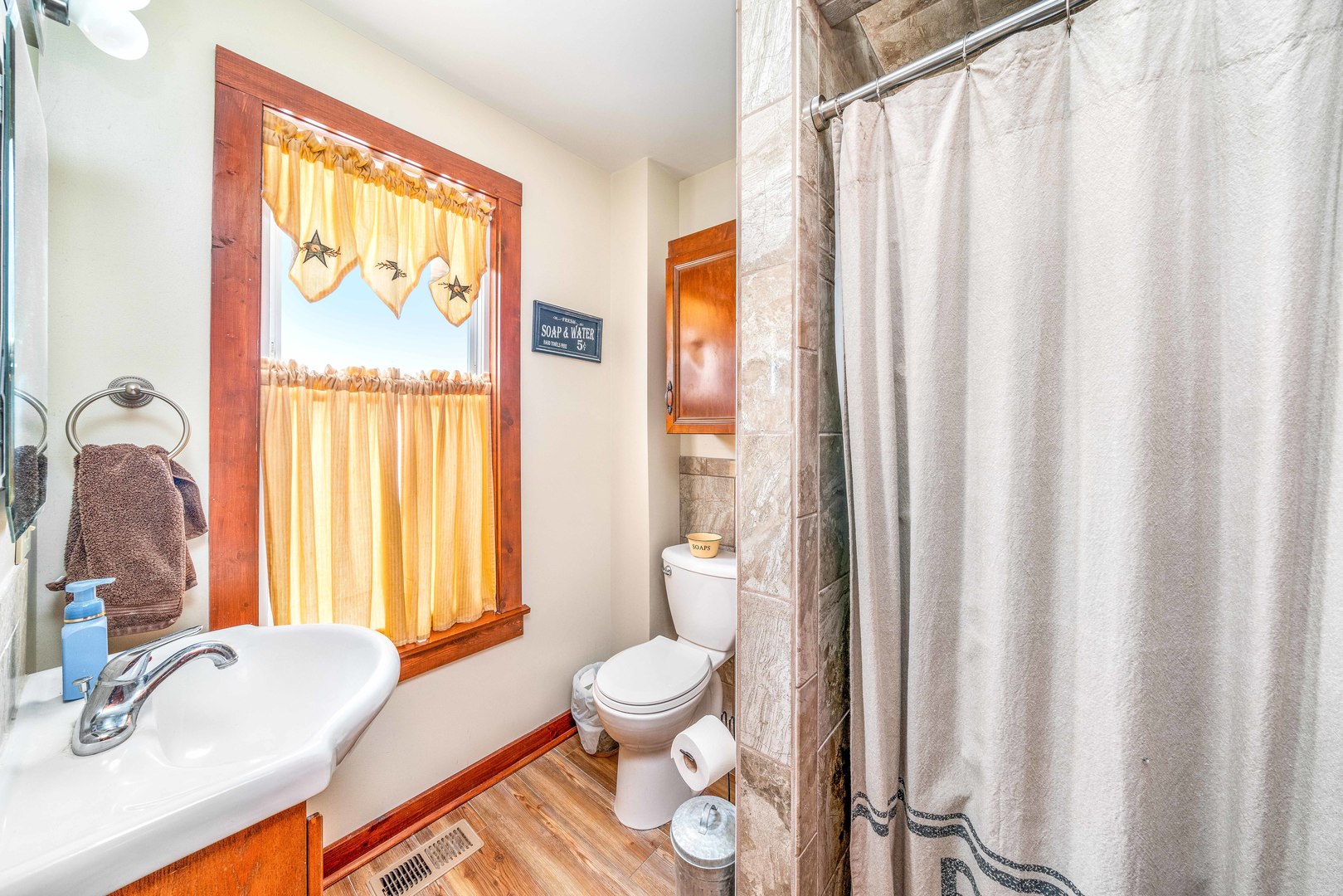 3478 Chicago Road Paw Paw, IL 61353 - Photo 17 of 49 a bathroom with a sink a toilet and a window