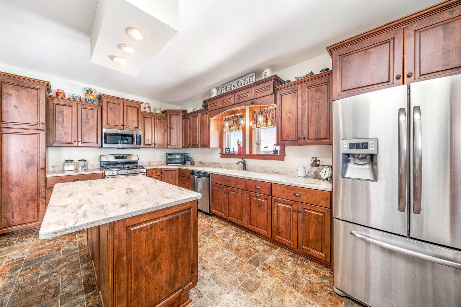 3478 Chicago Road Paw Paw, IL 61353 - Photo 7 of 49 a kitchen with stainless steel appliances granite countertop a refrigerator a sink dishwasher a stove and white cabinets with wooden floor