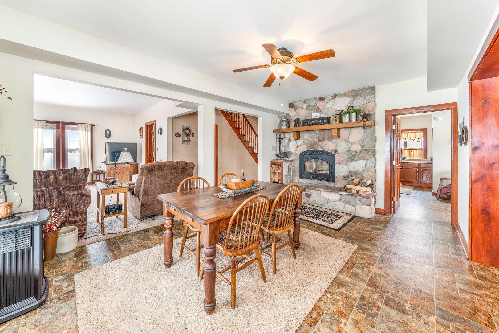 3478 Chicago Road Paw Paw, IL 61353 - Photo 9 of 49 a view of a dining room and livingroom with furniture wooden floor and a rug