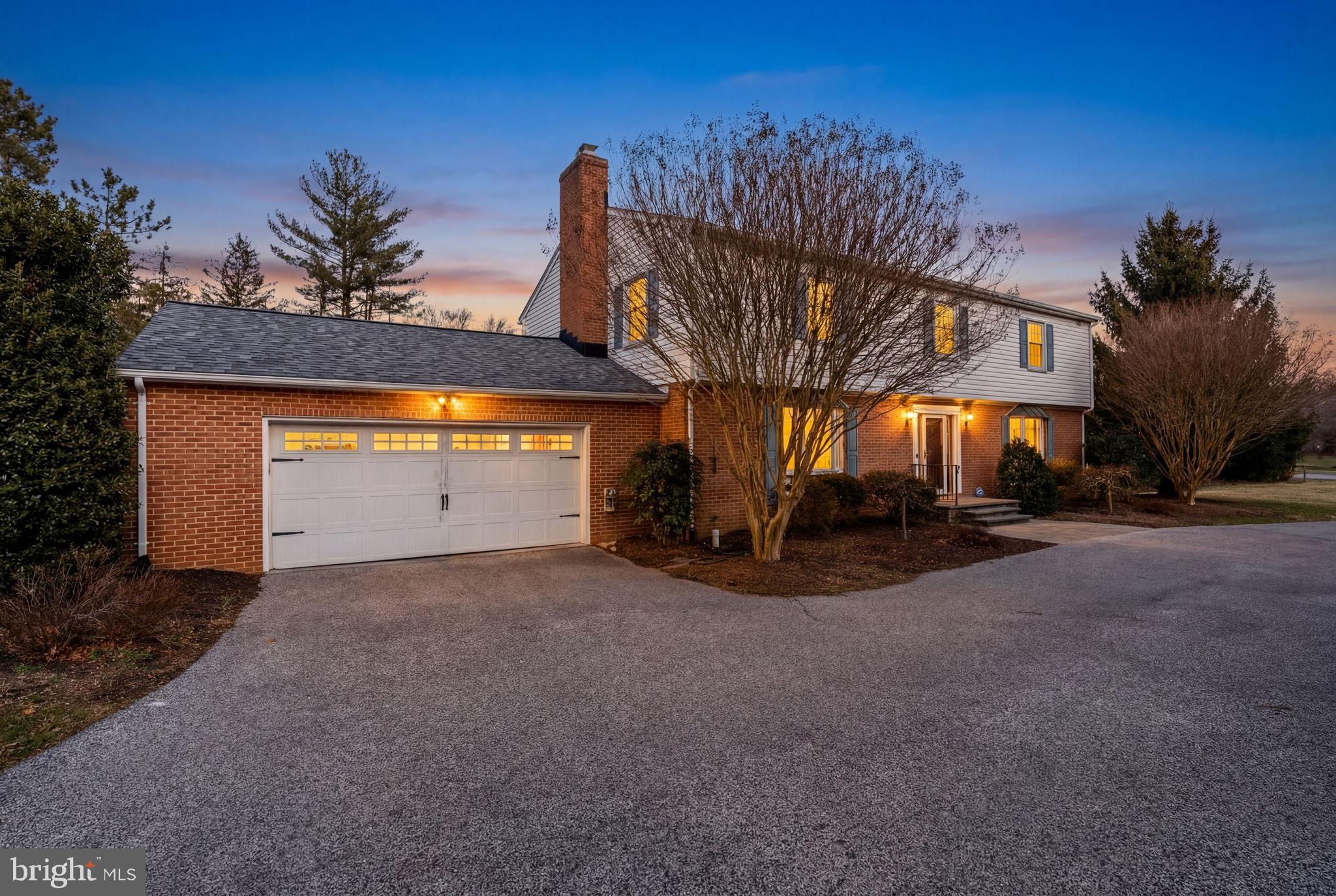 Charming home at dusk with inviting curb appeal.