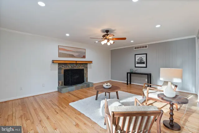 a view of a hallway with wooden floor and stairs