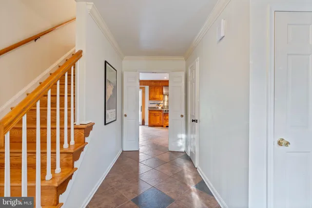 a dining room with furniture a chandelier and wooden floor