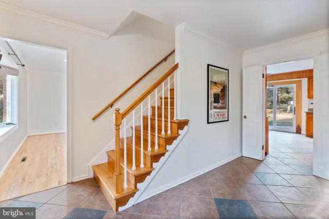 a view of a dining room with furniture wooden floor and a chandelier