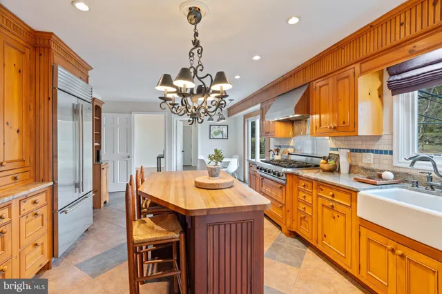 a kitchen with sink a window and cabinets