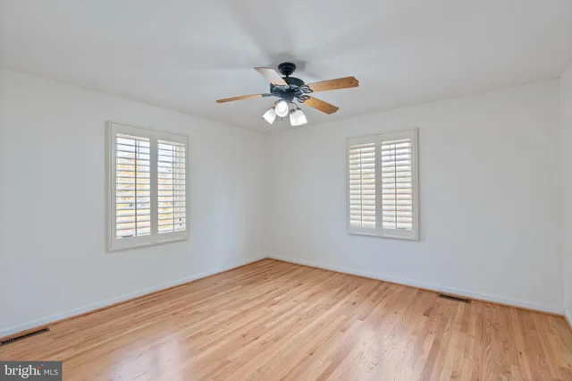 a bedroom with a bed a dresser and a chandelier
