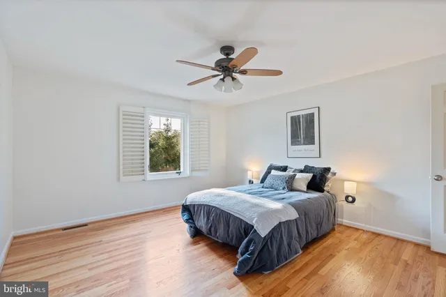 a bathroom with a granite countertop sink a toilet a mirror and shower