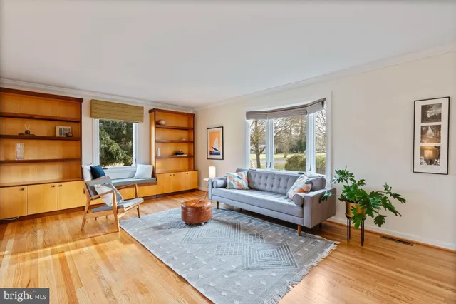 a living room with a wooden floor and a window