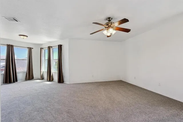 a view of room with window and ceiling fan