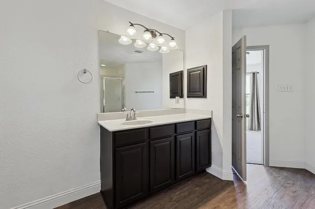 a bathroom with a double vanity sink and mirror