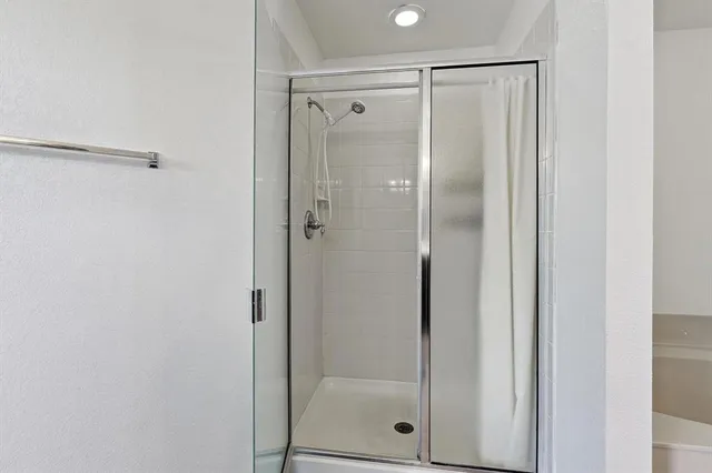 a bathroom with a glass shower door