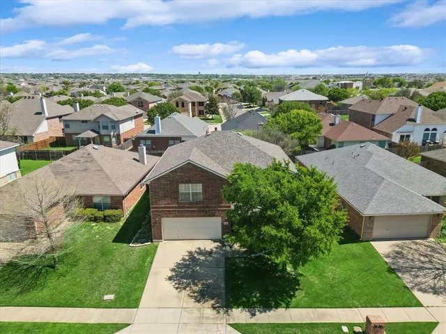 an aerial view of residential houses with outdoor space