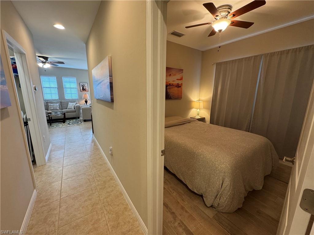 1431 Santiago Circle, Unit 1901 Naples, FL 34113 - Photo 20 of 29 a bedroom with a bed and a walk in closet