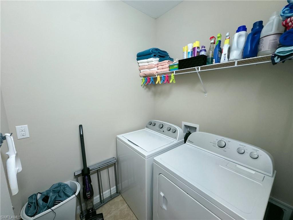 1431 Santiago Circle, Unit 1901 Naples, FL 34113 - Photo 23 of 29 a utility room with dryer and washer