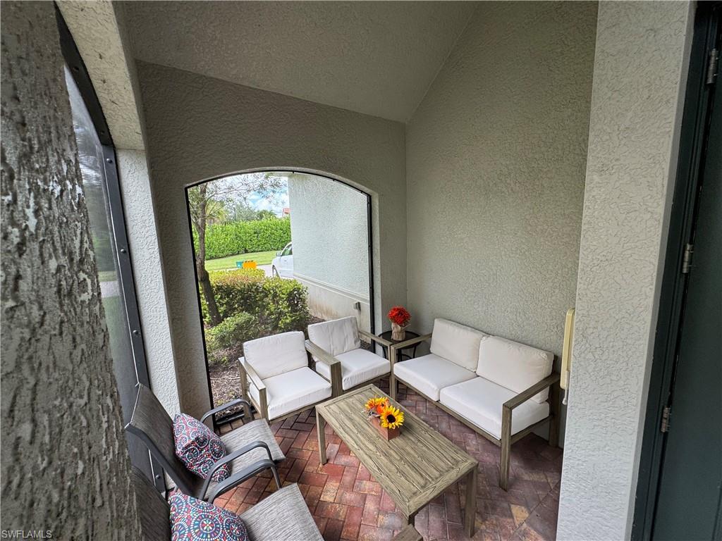 1431 Santiago Circle, Unit 1901 Naples, FL 34113 - Photo 25 of 29 a living room with furniture and a large window