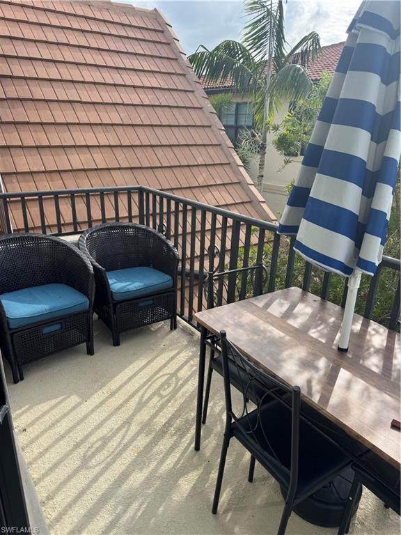 1431 Santiago Circle, Unit 1901 Naples, FL 34113 - Photo 29 of 29 a roof deck with a table and chairs