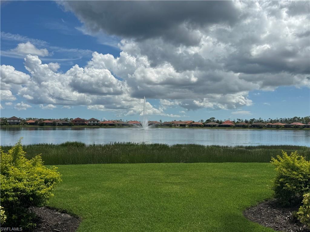 1431 Santiago Circle, Unit 1901 Naples, FL 34113 - Photo 3 of 29 a view of a lake from a yard