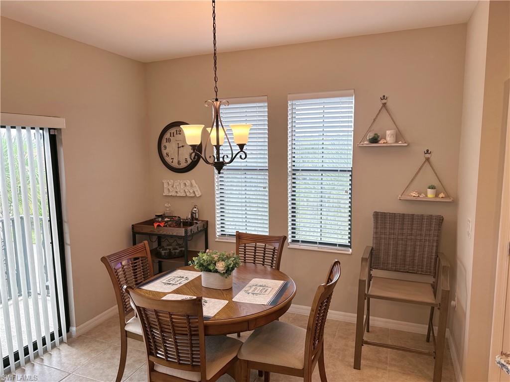1431 Santiago Circle, Unit 1901 Naples, FL 34113 - Photo 9 of 29 a view of a dining room with furniture and window