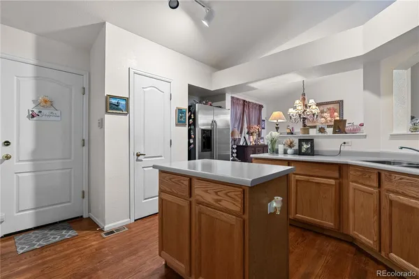a kitchen with white cabinets and sink