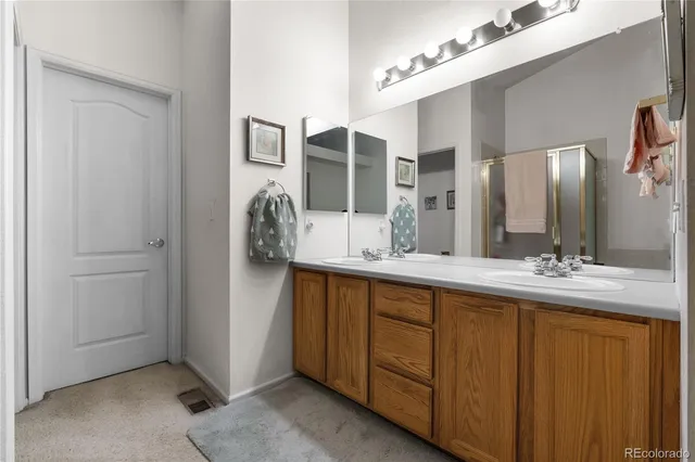 a bathroom with a double vanity sink and a mirror