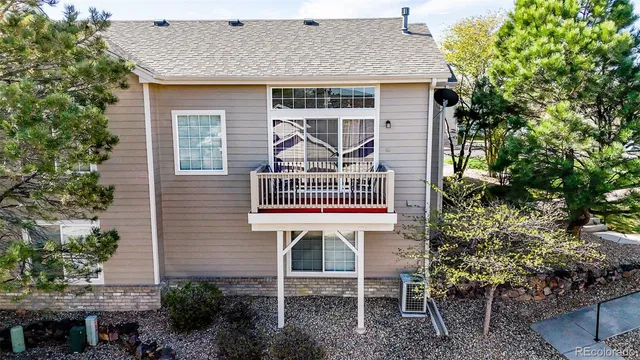a front view of a house with plants