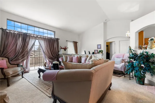 a living room with furniture a fireplace and a potted plant