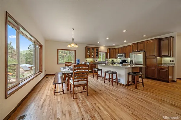 a view of a dining room with furniture window and wooden floor
