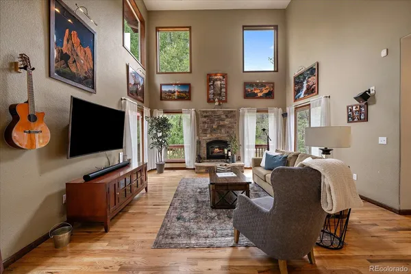 a living room with fireplace furniture and a flat screen tv